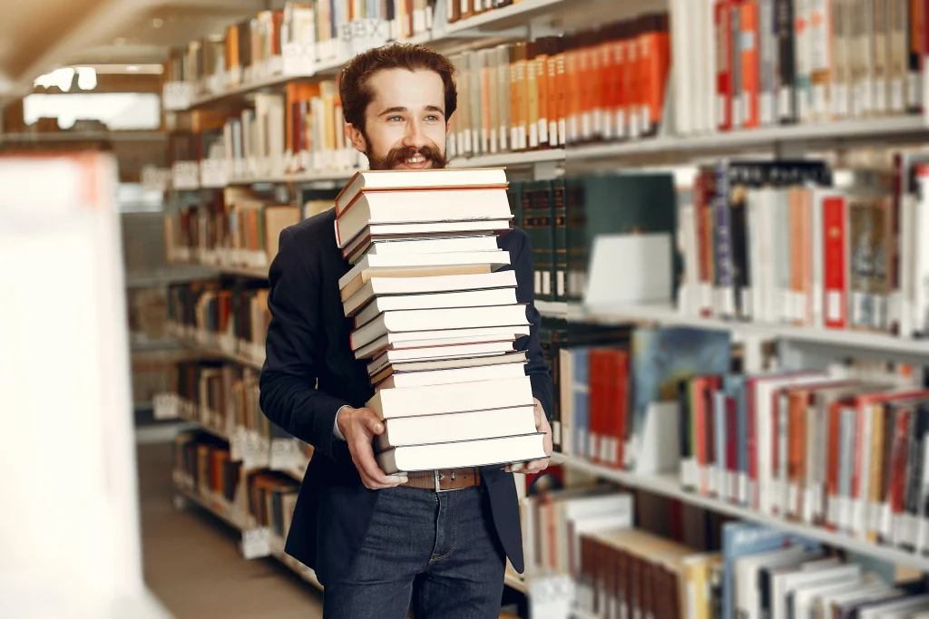 Man carrying books representing professional book marketing services.