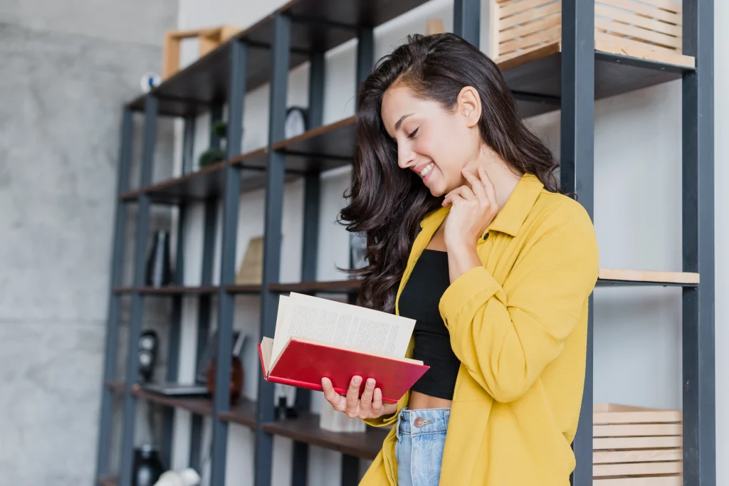 Woman reading a book, illustrating why authors need professional book marketing services.